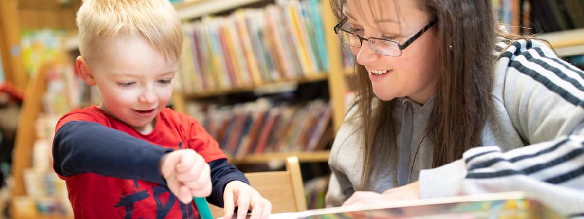 Home-Start volunteer and child in a library